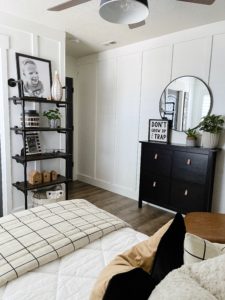 pipe shelves and black cabinet in kids bedroom